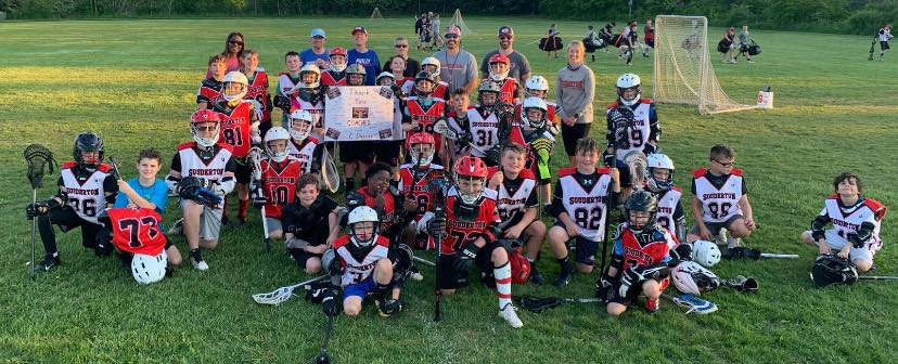 The entire C Level pose with their coaches after practice.  C2 and C1 level players practice together, but compete at varying levels.  