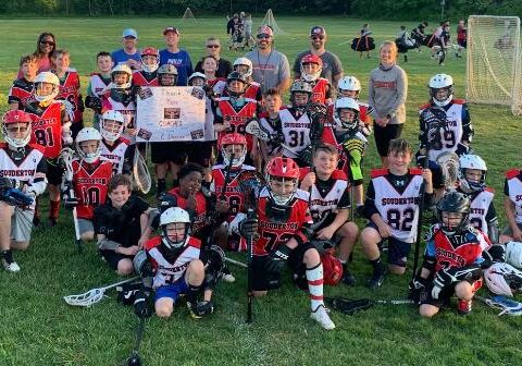 The entire C Level pose with their coaches after practice.  C2 and C1 level players practice together, but compete at varying levels.  